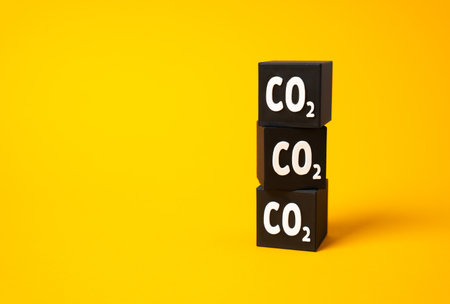 Column of CO2 cubes. Carbon footprint. Greenhouse gas calculator. measurement of environmental damage. Emission comparison across industries. Climate reporting standards, and carbon intensity.の写真素材