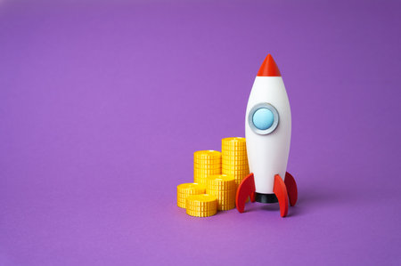Rocket startup and money coins. Profitable business. Fundraising. Attraction of investors. Innovative projects. High risk. Capital growth. Technological development.の写真素材