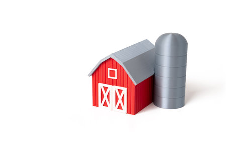 Farm barn on white background, figurine. Farming. Rural economy. Sustainable farming practices.の写真素材