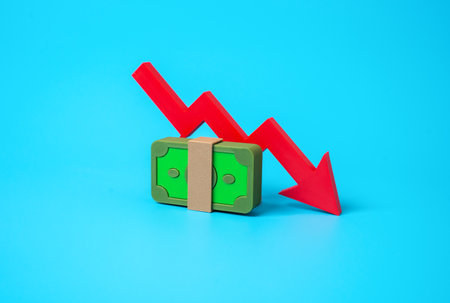 A stack of money and an arrow pointing down. A drop in income, salary cut, financial loss, reduced...