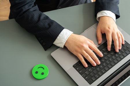 Businessman with laptop and green smiley. Symbol of productivity, motivation, and workplace...