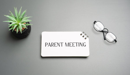 Parent meeting in school classroom, teachers and parents discussing student progress, education and...