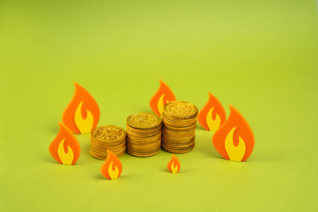 A pile of coins surrounded by fire. Danger of losing savings. Inflation, confiscation of savings....