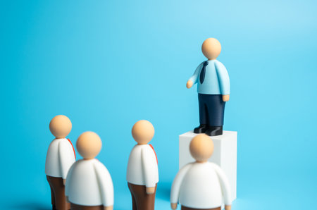 A politician stands at the podium delivering a speech to the assembled crowd. A business leader addresses his subordinates. Concept of leadership, public speaking, influenceの写真素材