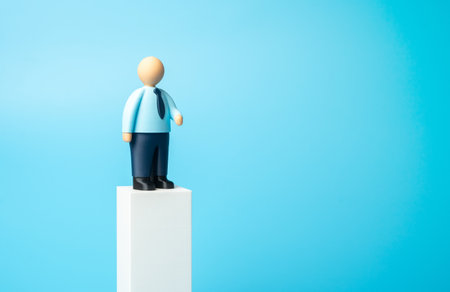 An office worker on a pedestal. Business presentation, space for text. Advertising, invitations to business events. Jobs, hiring, and recruiting. Leadership, recognition in career, corporate image.の写真素材