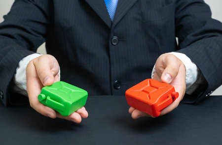 A businessman offers a choice between fossil and green fuels. Energy transition and environmental technologies. Ecology, renewable energy, and sustainability industry discussions.の写真素材