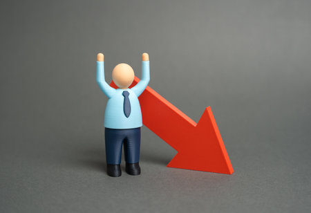 An office worker and a downward-facing arrow. Mass layoffs, salary cuts. Economic crisis, instability, and loss of motivation. Financial downturn, inflation, and unemployment.の写真素材