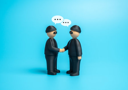 Two robbers agree to cooperate. An organized crime organization. Concept of conspiracy, illegal activity, and hidden agreements. Crime, investigation, and risk managementの写真素材