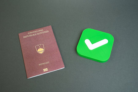Slovenian passport and approval check mark. Permission to enter or exit. Approval for obtaining a passport or citizenship. Permission for citizens to enter the country of arrival.の写真素材