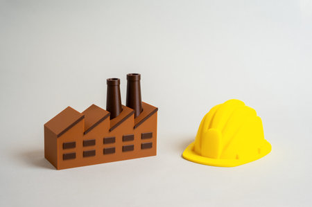 Factory and builder's hard hat. Factory work and blue-collar labor. Industrial development, production efficiency, and manufacturing sector growth.の写真素材