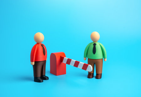 Two employees stand on opposite sides of a barrier. Keep your distance. Lack of trust and communication barriers in the workplace. Conflict resolution and HR relationsの写真素材