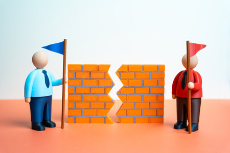 Two rivals and a crack in the wall symbolize conflict and mistrust. Forget old grievances and find a compromise. Negotiation and peace restoration. Conflict resolution, political tensionの写真素材