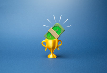 The winner's cup with a stack of bills inside. Prize fund. Financial success, reward for hard work, and business competition. Motivation, bonuses, investment returnsの写真素材