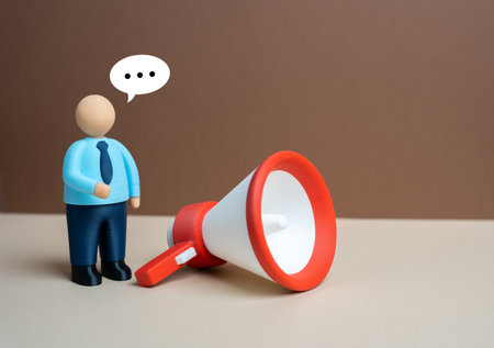 An office worker announces a message through a megaphone. Public address. Advertising and marketing. Recruiting. Communication, media influence, and business promotion in corporate culture.の写真素材