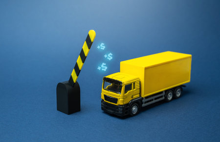 An open barrier lets a truck through. Tolls and toll roads. Payment of customs duty. Transportation infrastructure, cargo delivery, customs clearance. Concept of logistics, trade, and border control.の写真素材