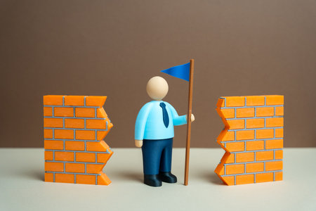 A leader with a blue flag breaks barriers and overcomes difficulties. Leadership and the art of leading. Business success, corporate training, motivation, personal achievement, overcoming challenges.の写真素材