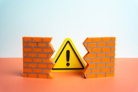 A warning sign bursts through a hole in the wall. A problem that destroys integrity. A warning about an error or malfunction that cannot be ignored for long. Cybersecurity, business risk assessmentの写真素材