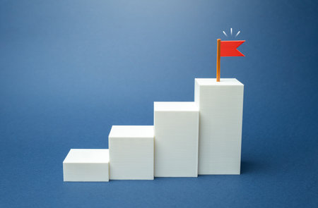 Goal flag and step-by-step achievement of the goal. Define and strive to achieve it. Motivation, leadership success, and career planning strategies.の写真素材