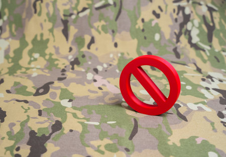 A prohibition sign on a military background. Rules and prohibitions in the army. Discipline and control. Security training, defense policy and organizational order.の写真素材