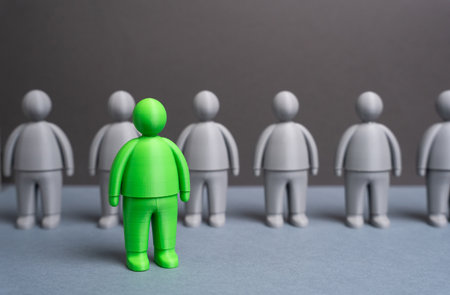 A green man among gray people. Talented. The best candidate for the job. Concept of leadership, creative hiring and HR analytics. Recruitment, innovation and team development.の写真素材