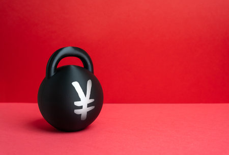 A weight with the Yen or Yuan symbol. Conceptually, it represents the burden of debt and economic problems. Financial stress and economic risk. Investment, banking and macroeconomic reports.の写真素材