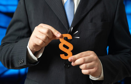 An official holds the law in his hands. Business lobbying for laws. Corporate influence, policy developmentの写真素材