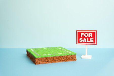 A plot of land is for sale. The plot area has a green lawn and a For Sale sign. Real estate opportunities support investment, development and property ownership.