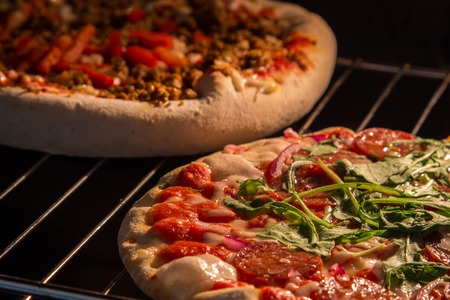 Chef prepares pepperoni pizza in the oven, view from the inside of the oven. Cooking in the oven.の写真素材