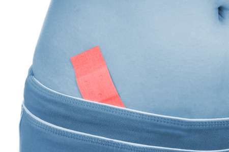 appendicitis covered with plaster, shown red, isolated on white backgroundの写真素材