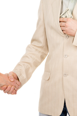 the man in suit agreed about the bribe and puts it in his pocket money isolated on white backgroundの写真素材