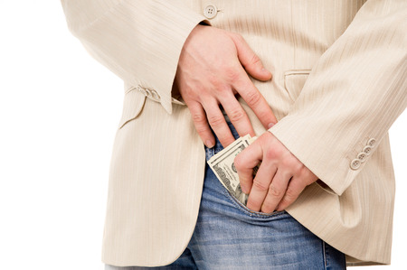 the man puts the money in his pants pocket isolated on white backgroundの写真素材