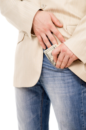 the man puts the money in his pants pocket isolated on white backgroundの写真素材