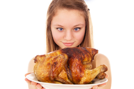 Beautiful girl eagerly looking for fried chicken isolated on white backgroundの写真素材