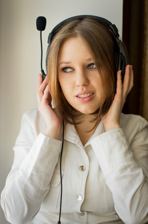 Beautiful girl listen music near the window, in houseの写真素材