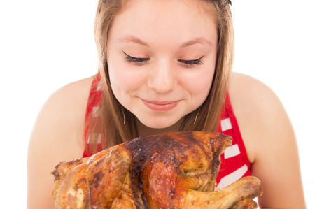 Beautiful girl loves chicken, isolated on white backgroundの写真素材
