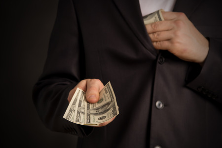 man wants to give you money, on a black backgroundの写真素材