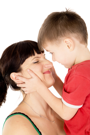 happy child kiss his mother isolated on white backgroundの写真素材