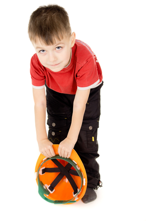 happy little boy standing with a helmet isolated on white backgroundの写真素材
