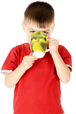 a small child drinks with cups isolated on white backgroundの写真素材
