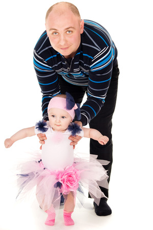 Happy dad with daughter helps make the first moveの写真素材