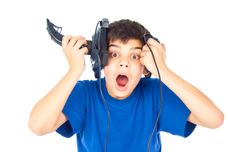 boy holds two joysticks and was surprisedの写真素材