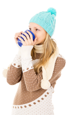 girl in winter hat with cupの写真素材