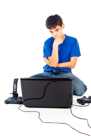 boy picks a laptop or joystickの写真素材