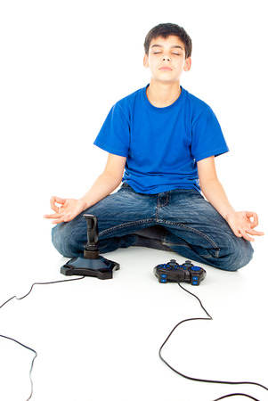boy meditating near the joystickの写真素材