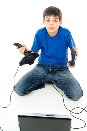 boy sitting with a computer and joystick isolatedの写真素材