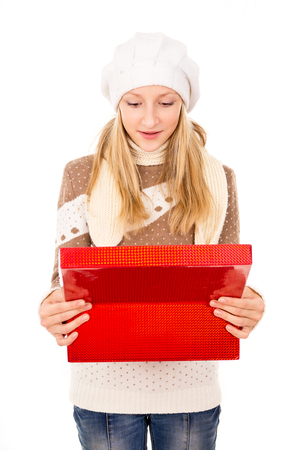 girl in a winter cap with a gift isolatedの写真素材