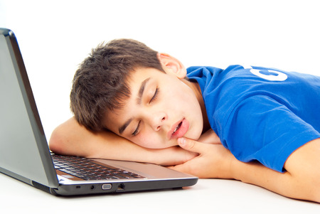 boy fell asleep at the notebook isolatedの写真素材