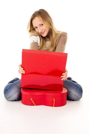 happy teenage girl sitting near the gift boxesの写真素材