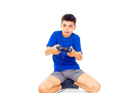 boy playing computer games on the joystick isolatedの写真素材