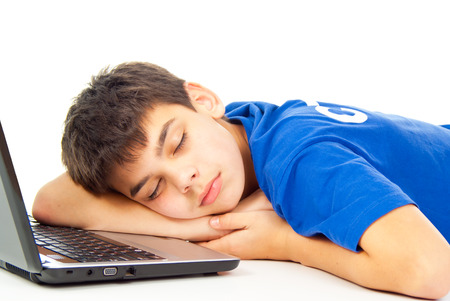 boy fell asleep at the notebookの写真素材